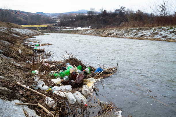 Plastic Bottles Floating On The Water, river pollution Pollution, used pvc plastic bottles floating in river. Garbage in water lake grunge stock pictures, royalty-free photos & images