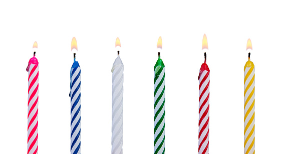 A set of multicolored candles for festive cupcake isolated on white background