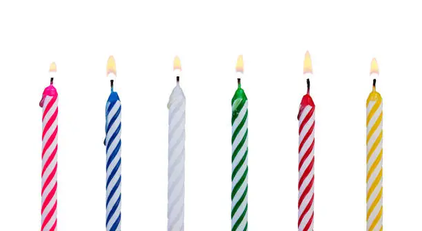 Photo of Set of multicolored candles for festive cupcake isolated on white background