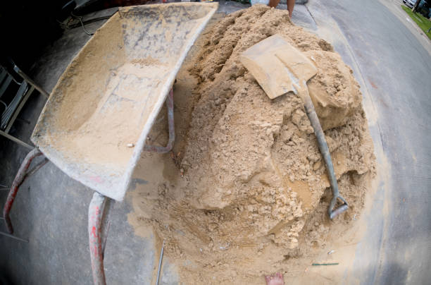 istock Spade stained and wheelbarrow for construction in site building area. construction work 1127110248