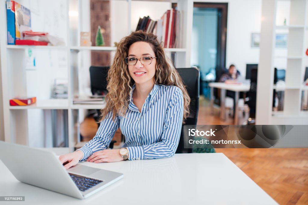 Portrait of happy female office worker. Office Stock Photo