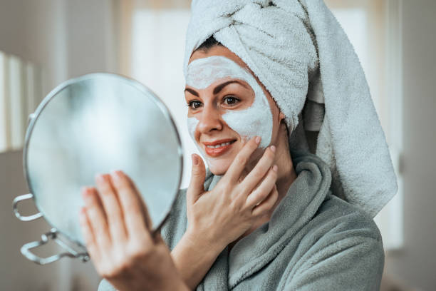 istock Close-up image of woman applying face mask. 1127111334