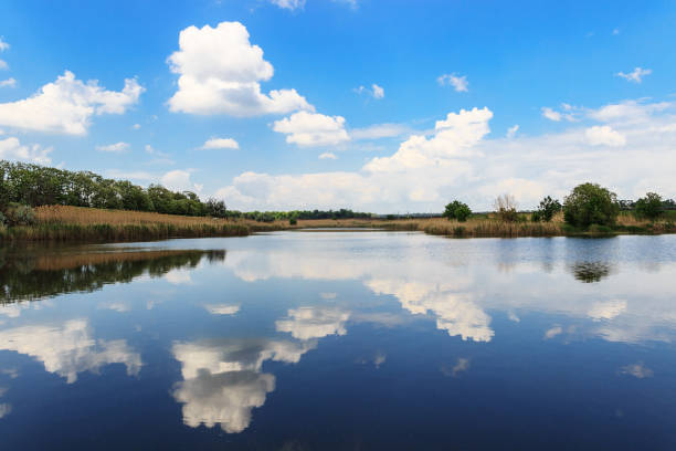 istock Summer landscape. Smooth lake water with reflections of clouds .. Background image. 1127111889