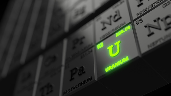 periodic table concept with black cubes. uranium element is glowing. 3d illustration