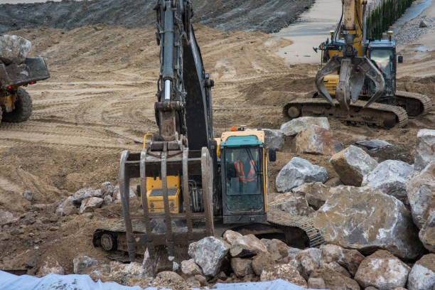 istock Dumper truck and mechanical digger on the beach 1127114674