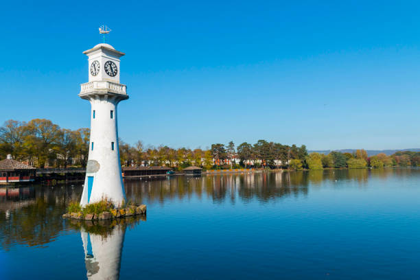 Captain Scott Monument at Roath Park Lake, Cardiff, UK Captain Scott Monument at Roath Park Lake, Cardiff UK on a crisp autumn day with lovely blue calm water and sky. cardiff wales stock pictures, royalty-free photos & images