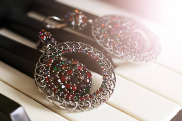 istock Large round earrings with stones on piano 1127123526