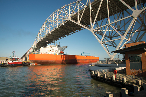 Oil Tanker with a tug boat escort passing under the Corpus Christi Harbor Bridge