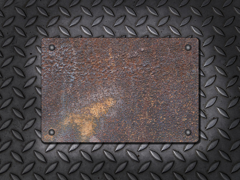 Old metal plate sign with rivets on steel background. With copy space for your own text.