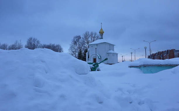 istock Snow-covered Russian chapel among snowdrifts 1127125053