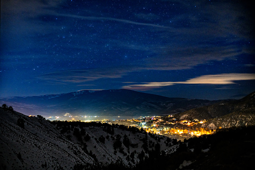 Gypsum Colorado Night Time Exposure in Winter - Night photography of town lit up in valley surrounded by mountains with views of the stars and sky. Gypsum, Colorado, Vail Valley, Colorado USA.