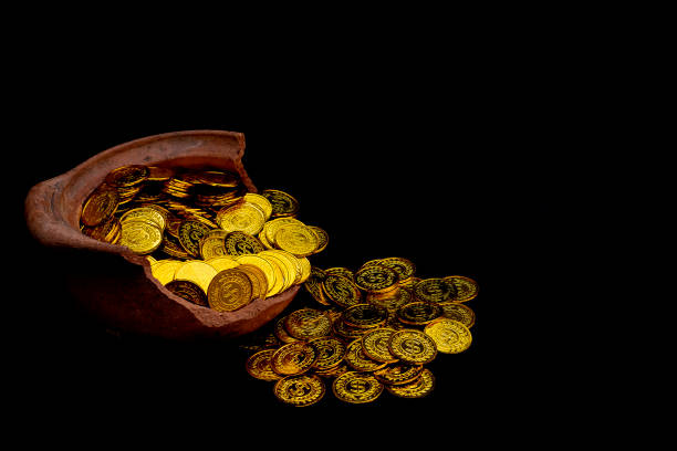 istock Stacking gold Coin in broken jar on black background,  Money stack for business planning investment and saving future concept 1127125382