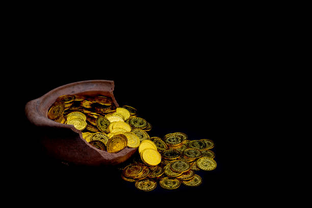 istock Stacking gold Coin in broken jar on black background,  Money stack for business planning investment and saving future concept 1127125396