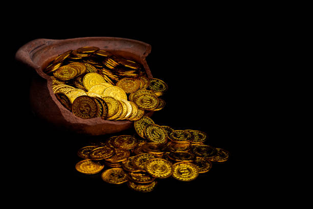 istock Stacking gold Coin in broken jar on black background,  Money stack for business planning investment and saving future concept 1127125441