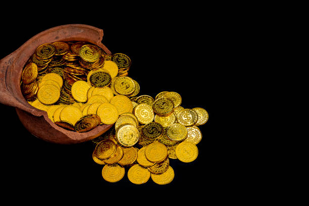 istock Stacking gold Coin in broken jar on black background,  Money stack for business planning investment and saving future concept 1127125459