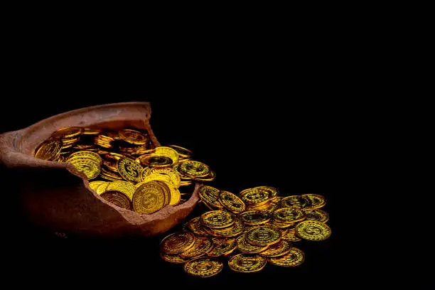 Photo of Stacking gold Coin in broken jar on black background,  Money stack for business planning investment and saving future concept