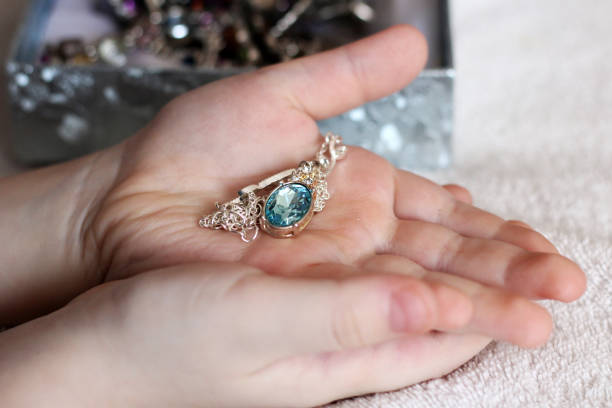 istock Children's hands holding a beautiful chain with a pendant 1127126370