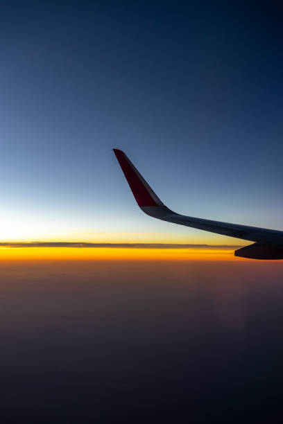 istock The wing of airplan in front of sunset time. 1127126766