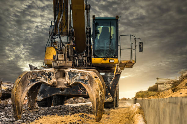 istock Dumper truck and mechanical digger on the beach 1127126915