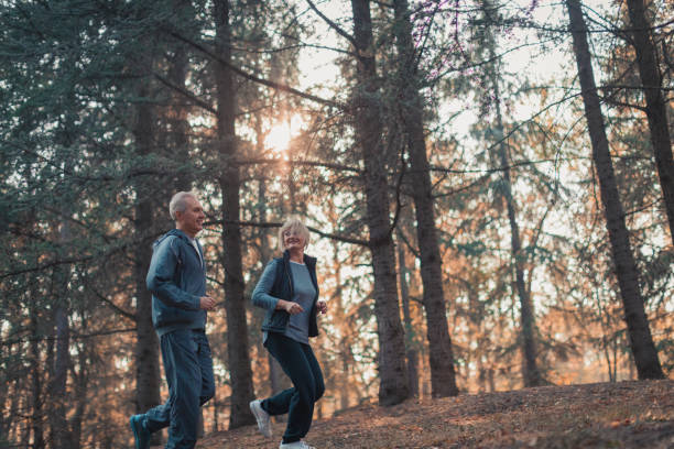 istock Senior couple jogging in a forest 1127128793