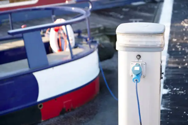 Electric charging point for boat and barge at marina mooring on canal uk