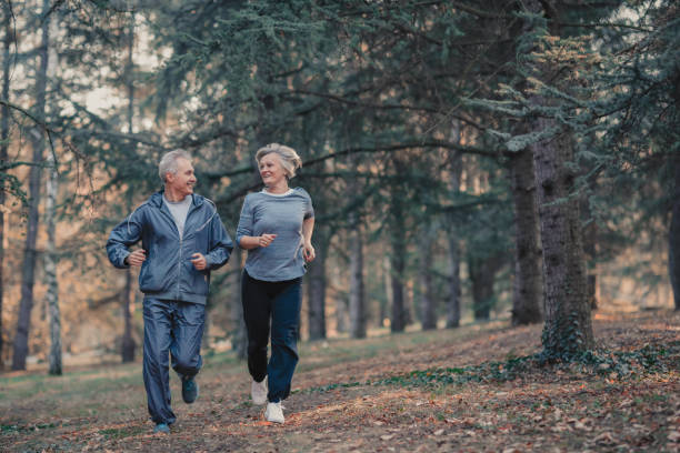istock Senior couple jogging in a forest 1127128908