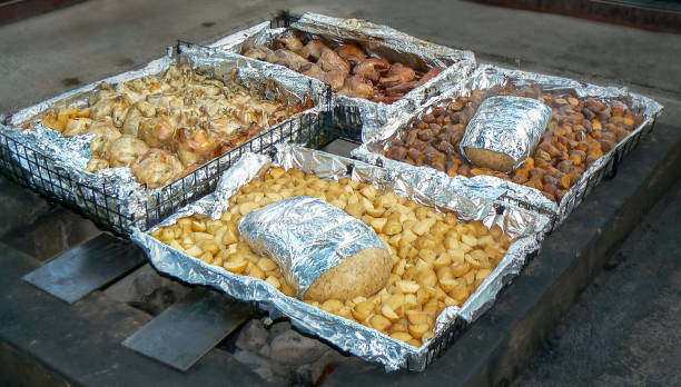 Traditional hangi meal, cooked underground in an earth oven by Maori people, Rotorua, North Island, New Zealand stock photo