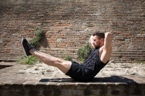 istock Bearded athlete doing a side crunch outside 1127131812