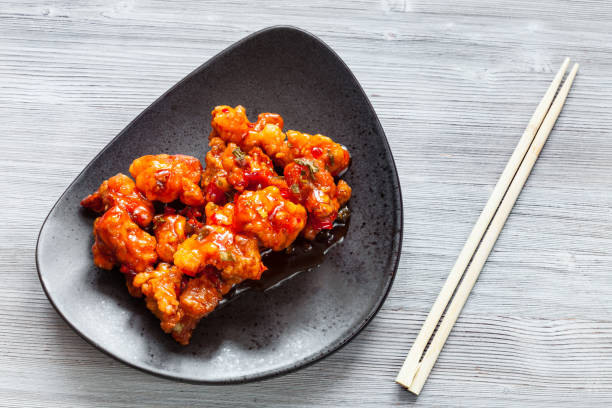 istock spicy fried Chicken with chopsticks close up 1127138996