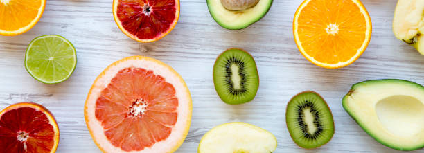 istock Various fresh fruits on white wooden table, overhead view. Summer background. 1127139673