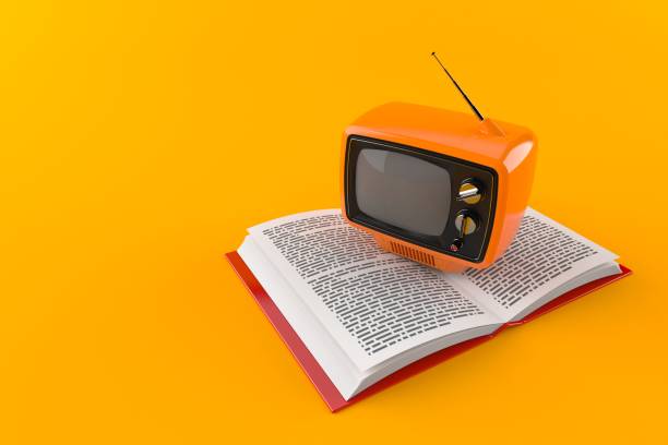 Old TV on open book stock photo
