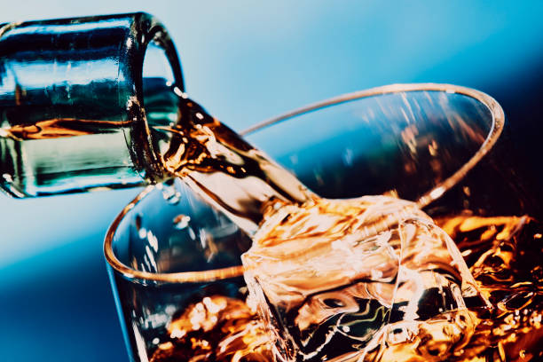 istock Pouring a glass of whiskey on ice 1127143264