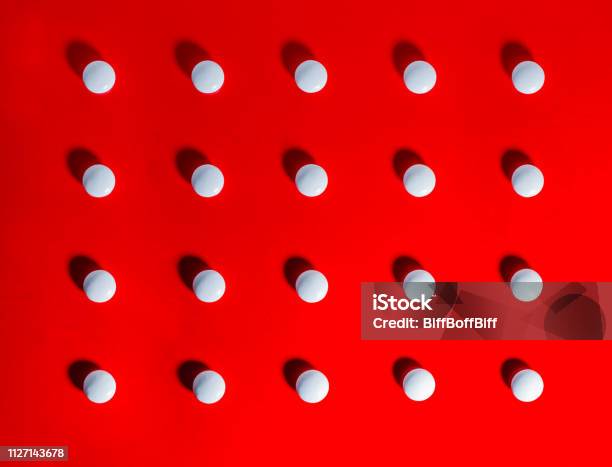 White Pills Against Red Background Stock Photo - Download Image Now - Pill, Red Background, Conformity