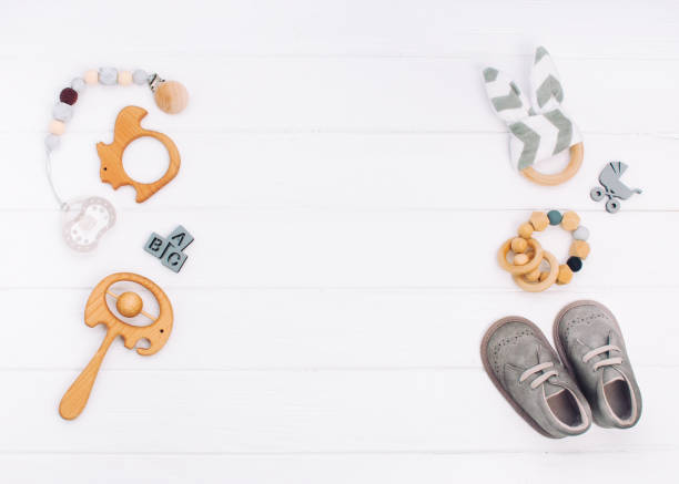 Baby accessories on white wooden background