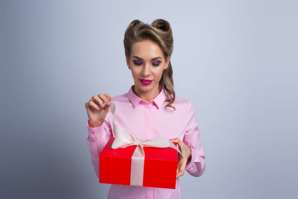 istock Happy woman with gift 1127147398