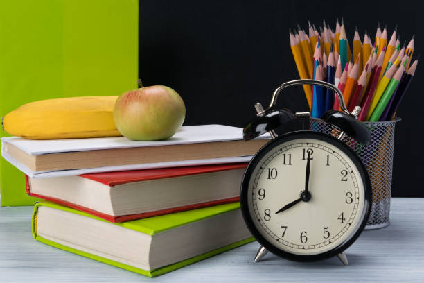 istock table with textbooks, pencils and school lunch, close-up 1127147749