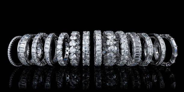 Multiple eternity wedding rings standing on black background White gold eternity (infinity) diamond rings with variously cut diamonds diamond ring photos stock pictures, royalty-free photos & images