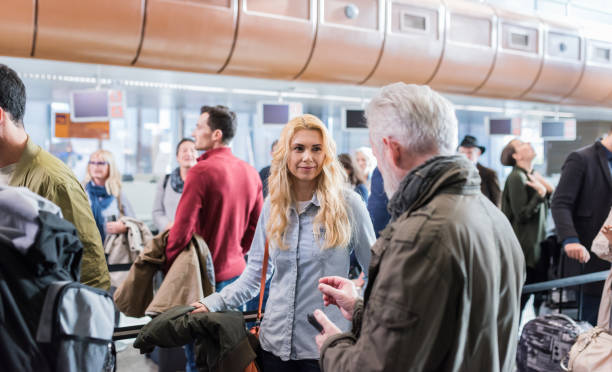 istock Group Of People Standing In Queue At Boarding Gate 1127151471