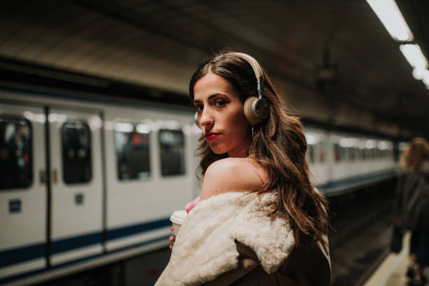 istock Young woman with headphones inside subway station platform 1127151570