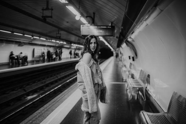 istock Young woman on a bench inside an underground station platform 1127151586