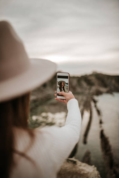 istock Young woman taking her selfie picture 1127153021