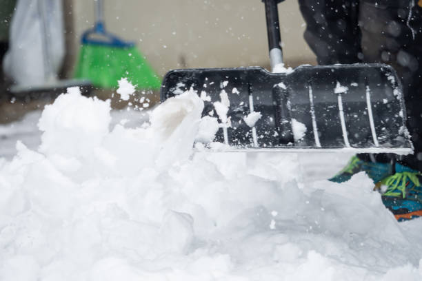 istock Someone is  shoveling snow outside in winter while it is snowing 1127154284