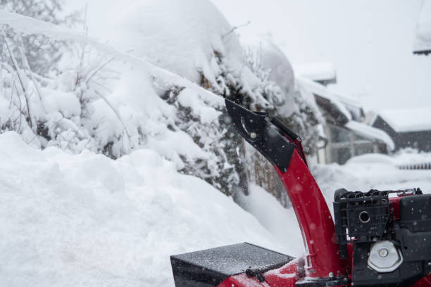 istock Someone uses a snowthrower outdoors in winter while it is snowing 1127154499