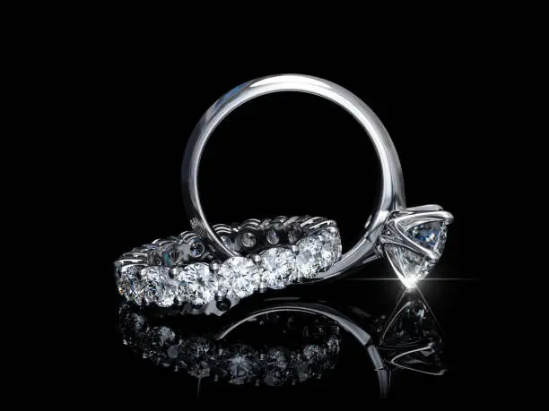 Photo of Interwoven diamond engagement ring, wedding ring on black background