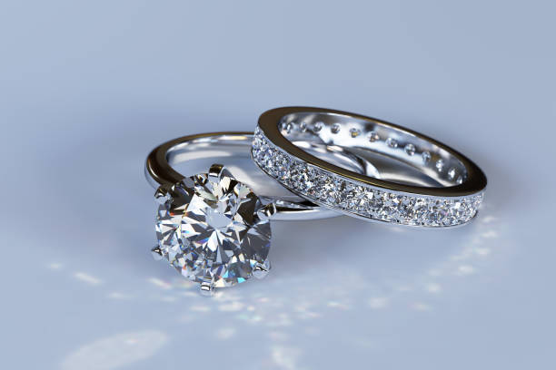 anello di fidanzamento diamante, fede nuziale su sfondo lucido blu - ring diamond jewelry wedding foto e immagini stock