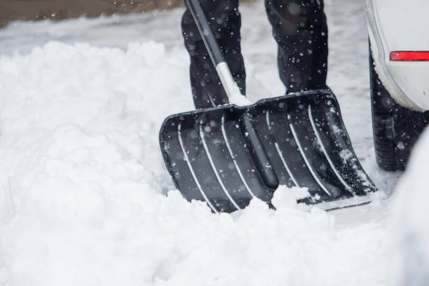 istock Someone is  shoveling snow outside in winter while it is snowing 1127154712