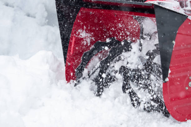istock Someone uses a snowthrower outdoors in winter while it is snowing 1127154761