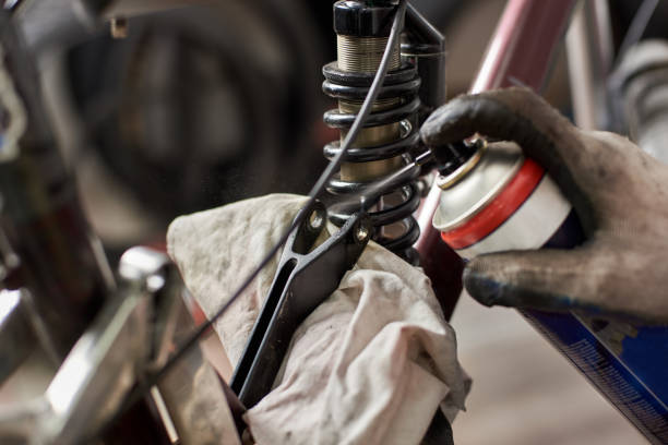 istock Male mechanic working in bicycle repair shop using tools 1127154930