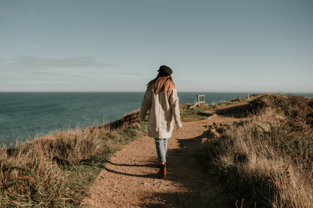 Young woman walking on dirt road