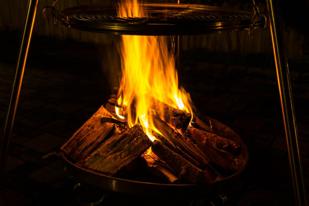 istock Fire bowl and grill over warm orange fire flames 1127155744